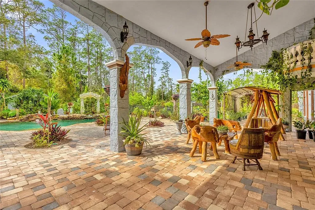 Patio with earth-tone pavers and tropical plants. Feels a vacation corner.