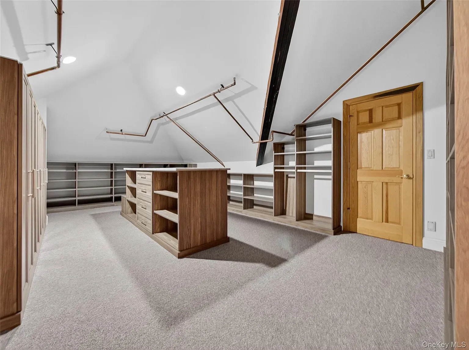 Attic hangout vibes. Sloped ceilings, white walls, and those beams actually work.