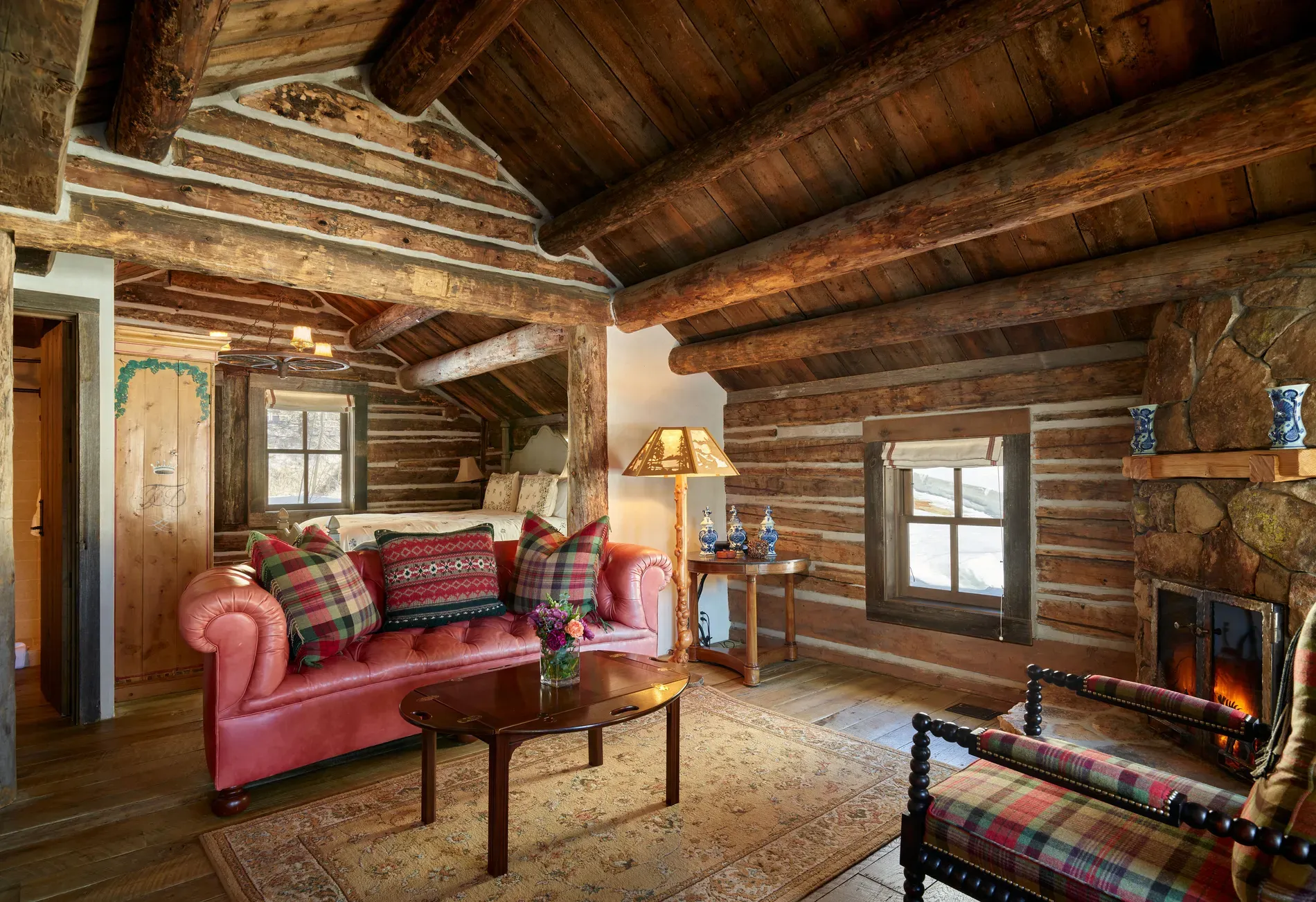 Okay, this snug log room — love the sloped ceiling, maybe a loft?