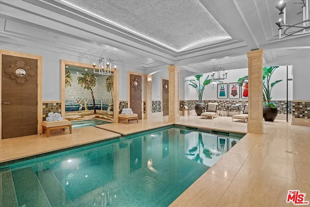 Indoor pool on marble floors with chandeliers. Not subtle, but gorgeous.
