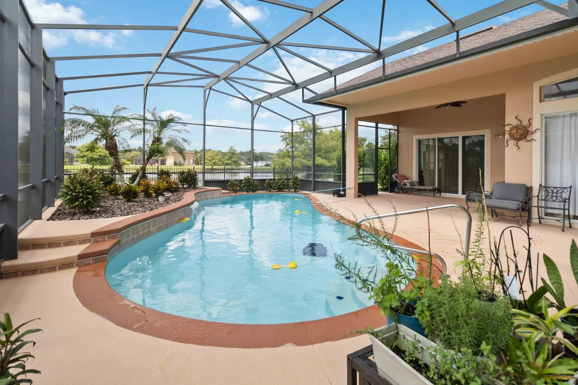 Screened-in pool vibes—turquoise water. Not sure about the screen, but privacy.