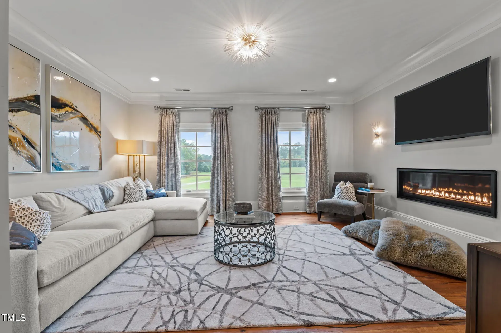 Cozy zone—neutral walls, pale floors, sectional begging for naps.