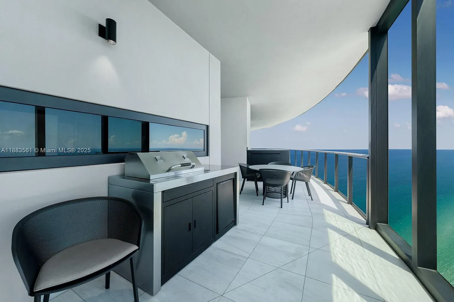 Balcony grill with ocean air? Yes please. Tiles look beach-sand adjacent.