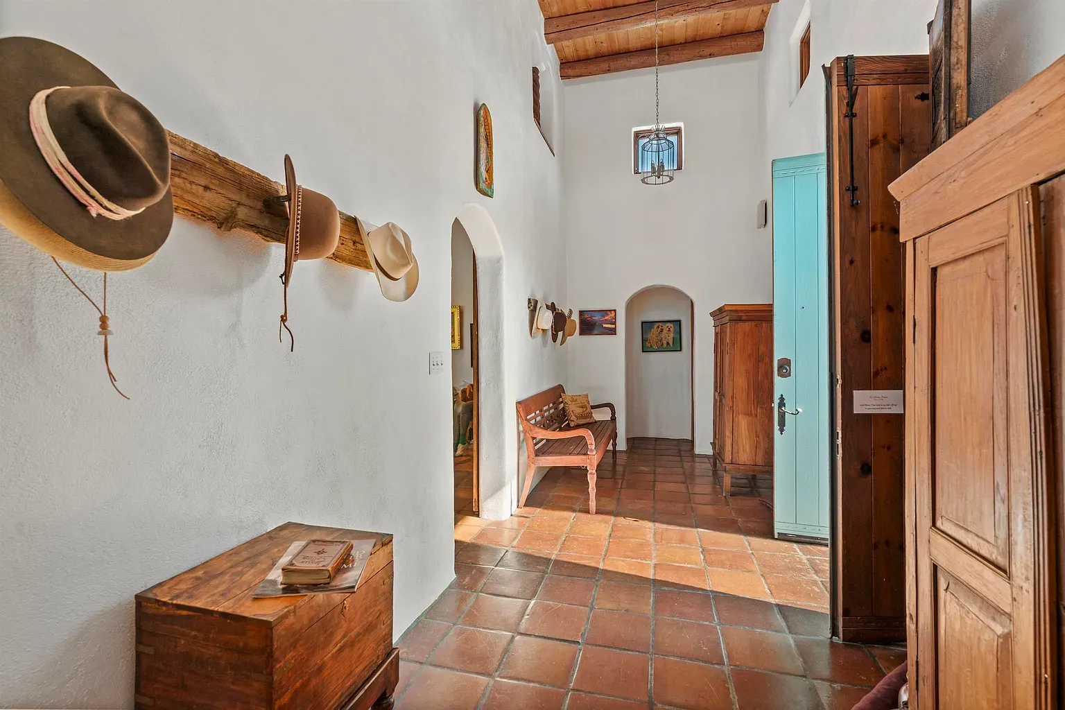 Creamy walls, terracotta floor, light pouring from above. Simple and perfect entry.