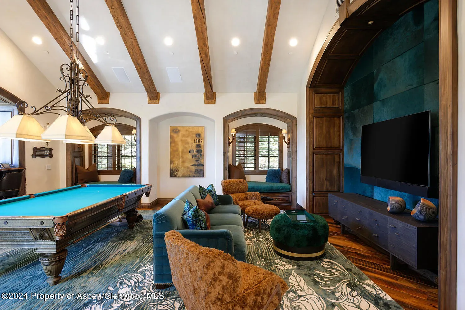 Turquoise pool table pops against the beams. I'd actually host game night.