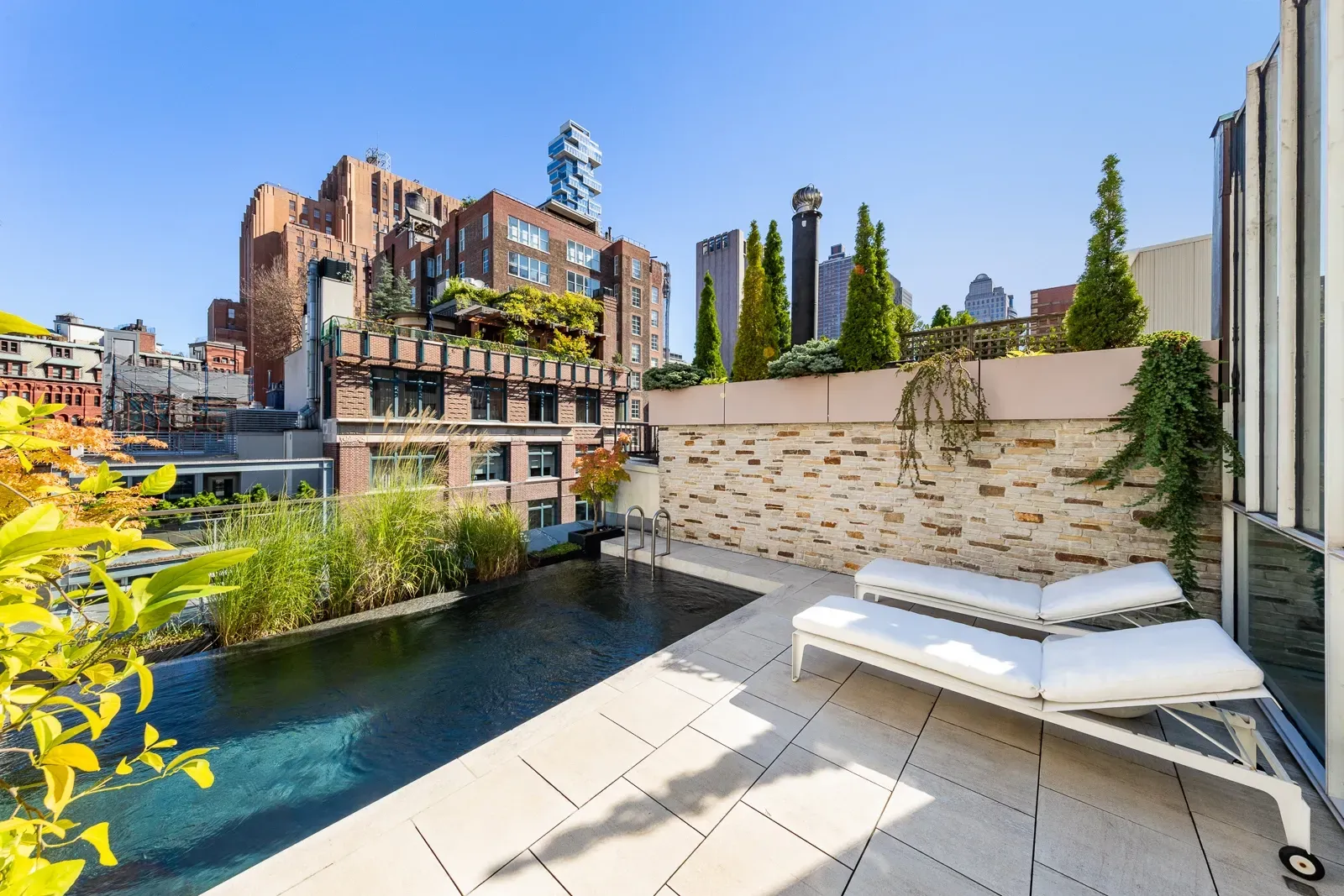And then, rooftop pool! Light stone everywhere. City views and spa vibes.