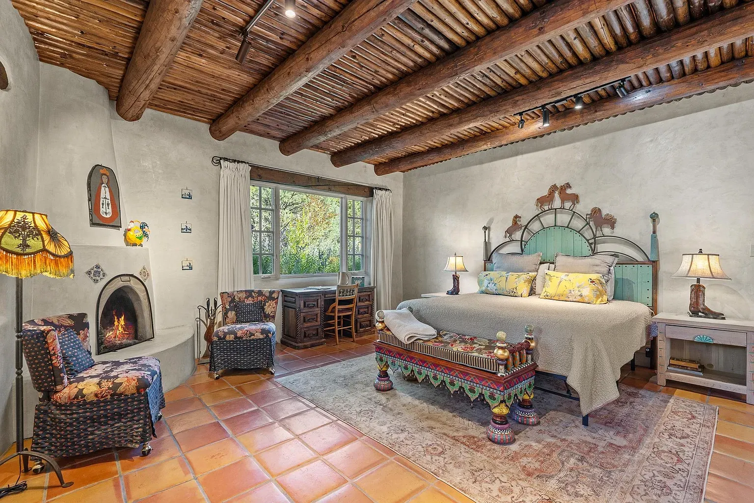 Beamed ceiling over a calm bedroom. Feels grounded and quiet.