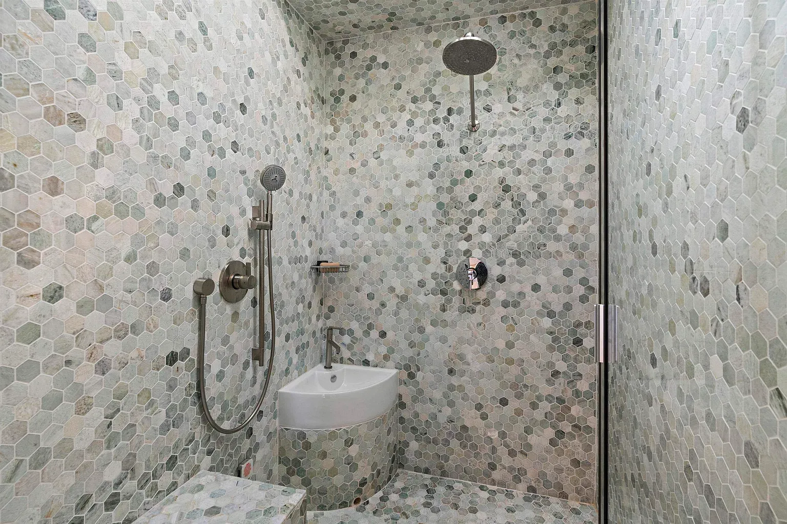 Hex tile mosaic is gorgeous. Soft greens make it feel a spa.