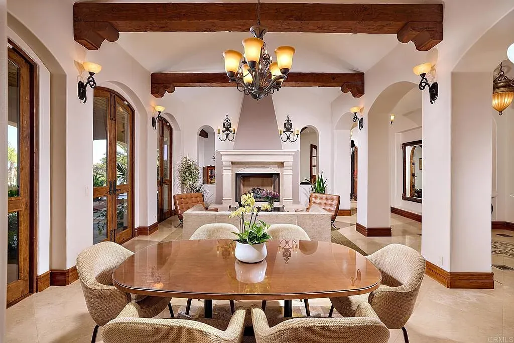 Dining room mixes cream walls and dark ceiling beams. Simple and kinda perfect.