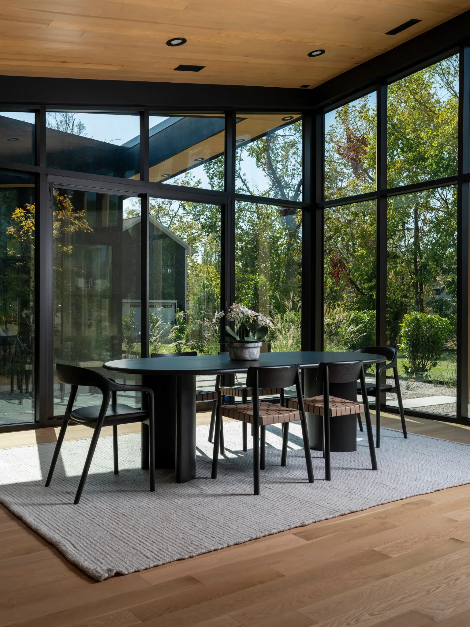 Simple black dining setup, all about the view through those huge windows.