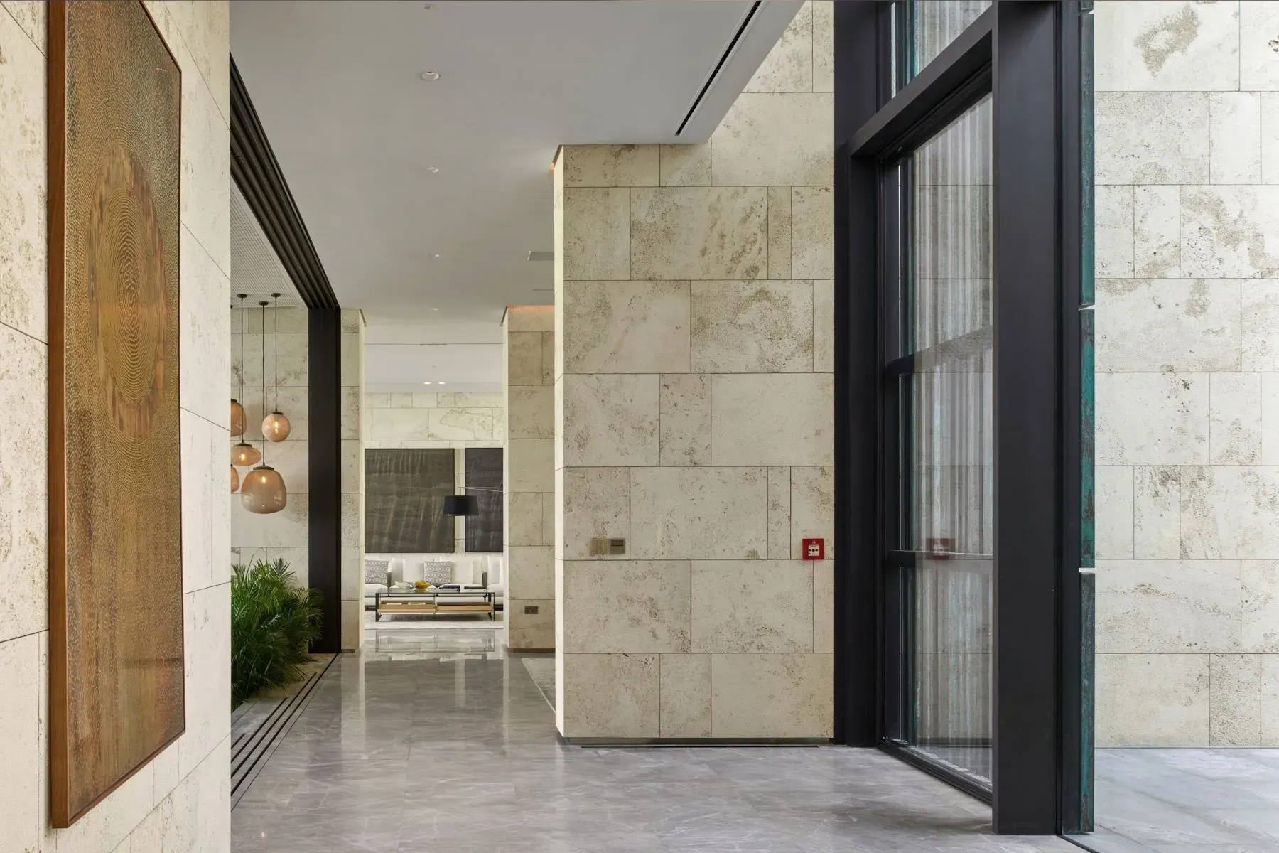 Entry is glassy and bright. stone walls feel a spa.