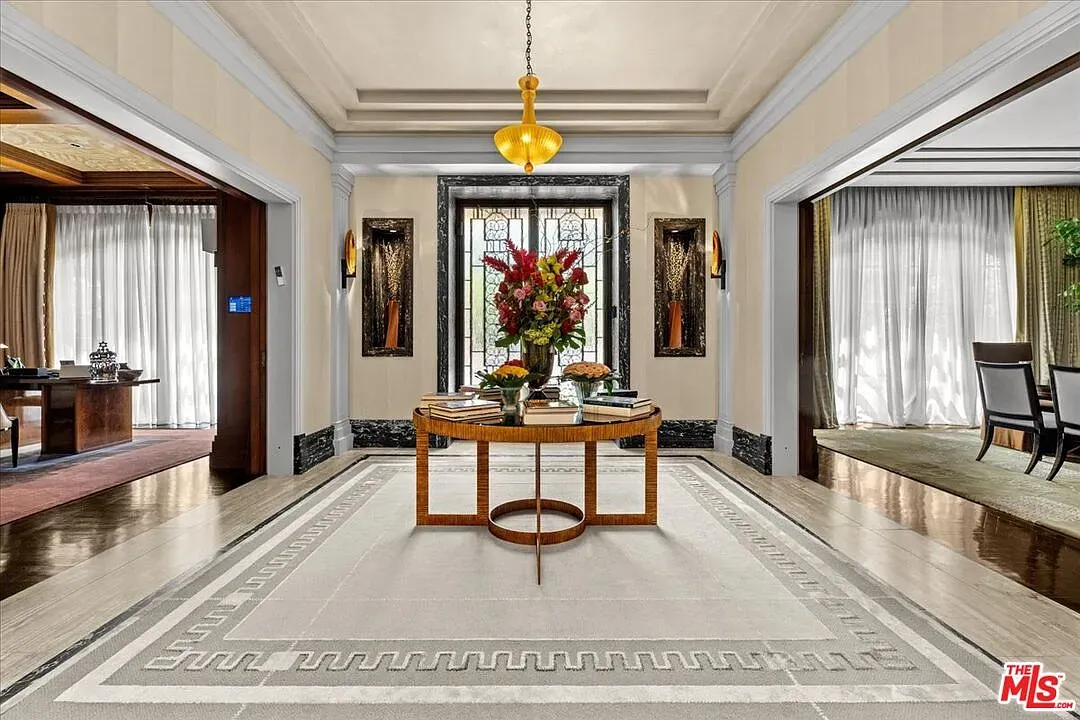 Geometric stone floor steals the foyer shot. Love the pattern mix.
