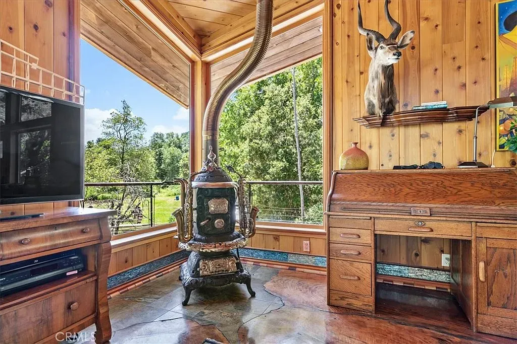 Ceiling and walls all wood. Cozy cabin energy without feeling dark.