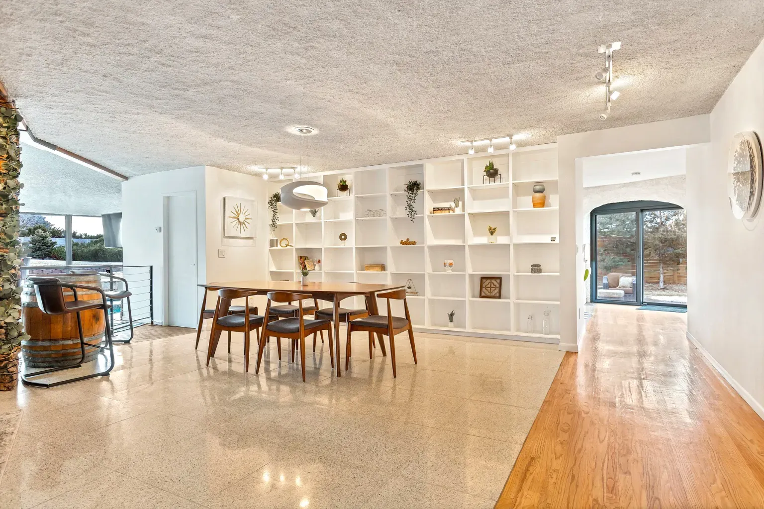 Dining area is bright, oak floors shining, windows doing all the work.