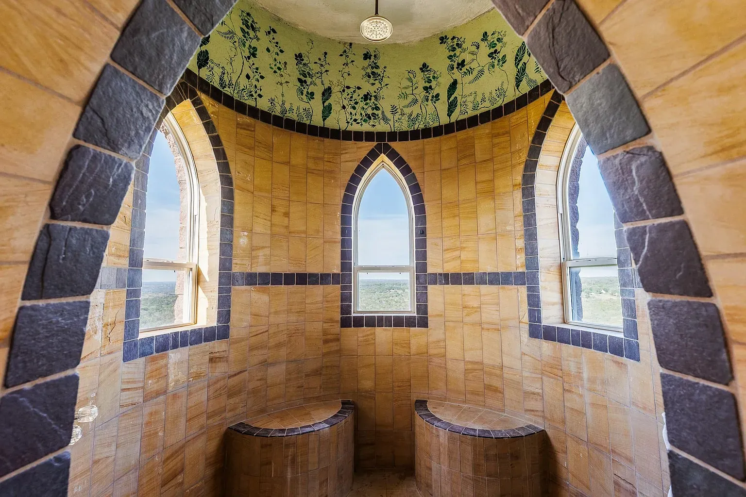 Little turret room! Sandstone walls, moody base trim, feels a reading nook.