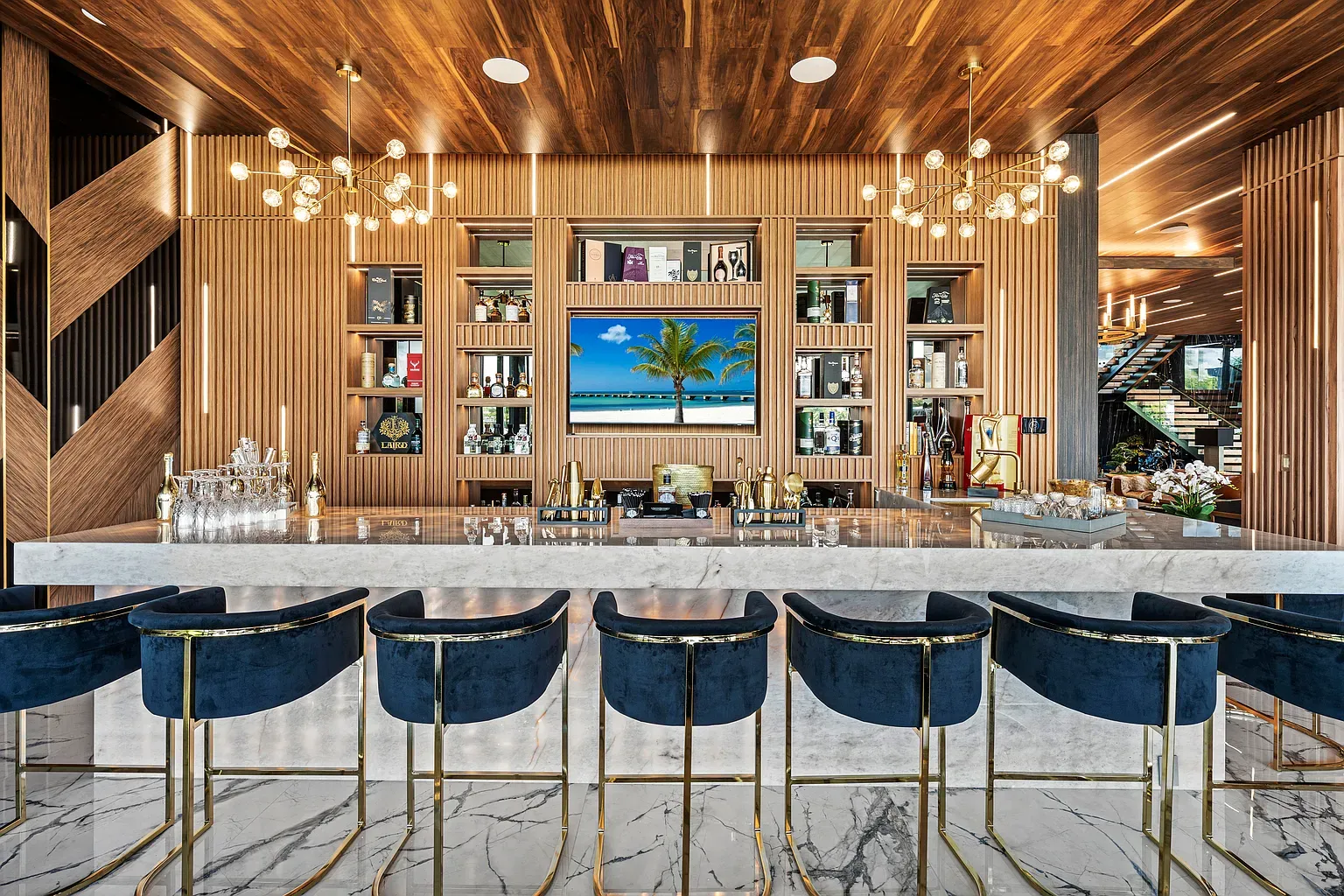 Home bar goes full marble. Backlighting makes everything look fancy.