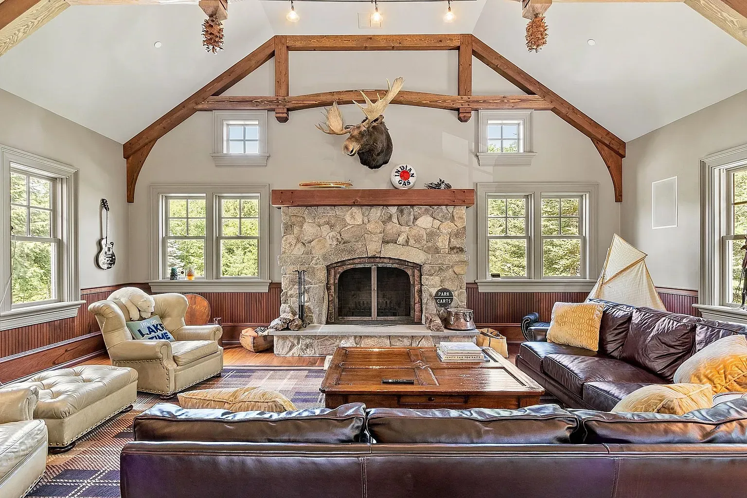 Stone fireplace and ceiling beams—mountain lodge energy, but comfy.