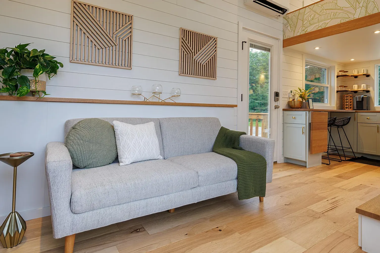 The floors carry the light. Cozy corner feels a reading spot.