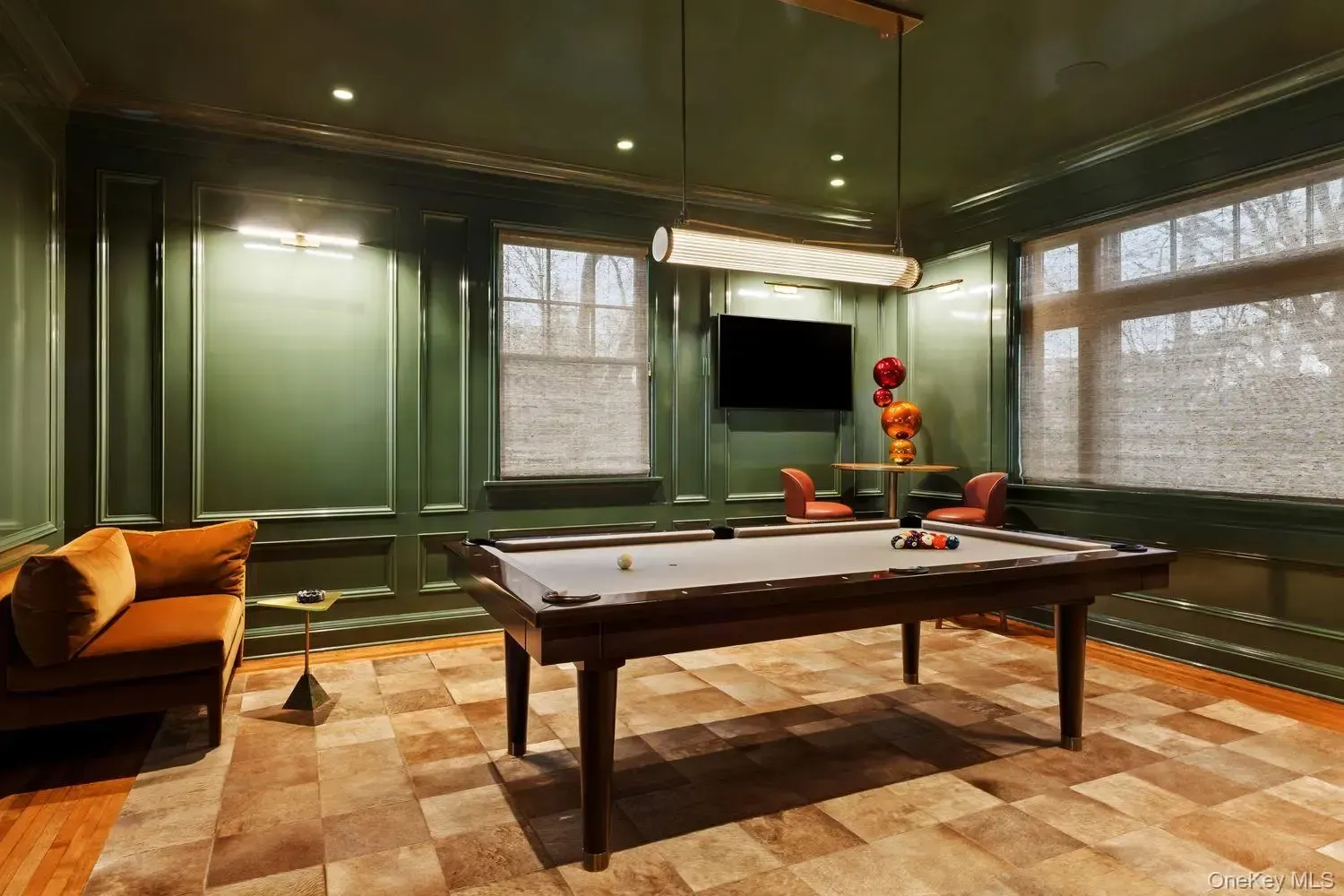 Moody green walls and a slick pool table. Game night sorted.