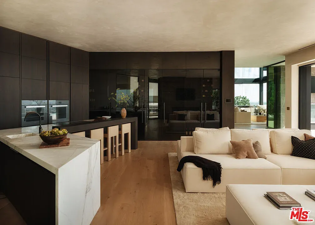 Kitchen goes dark against light floors. Clean lines, still feels cozy somehow.