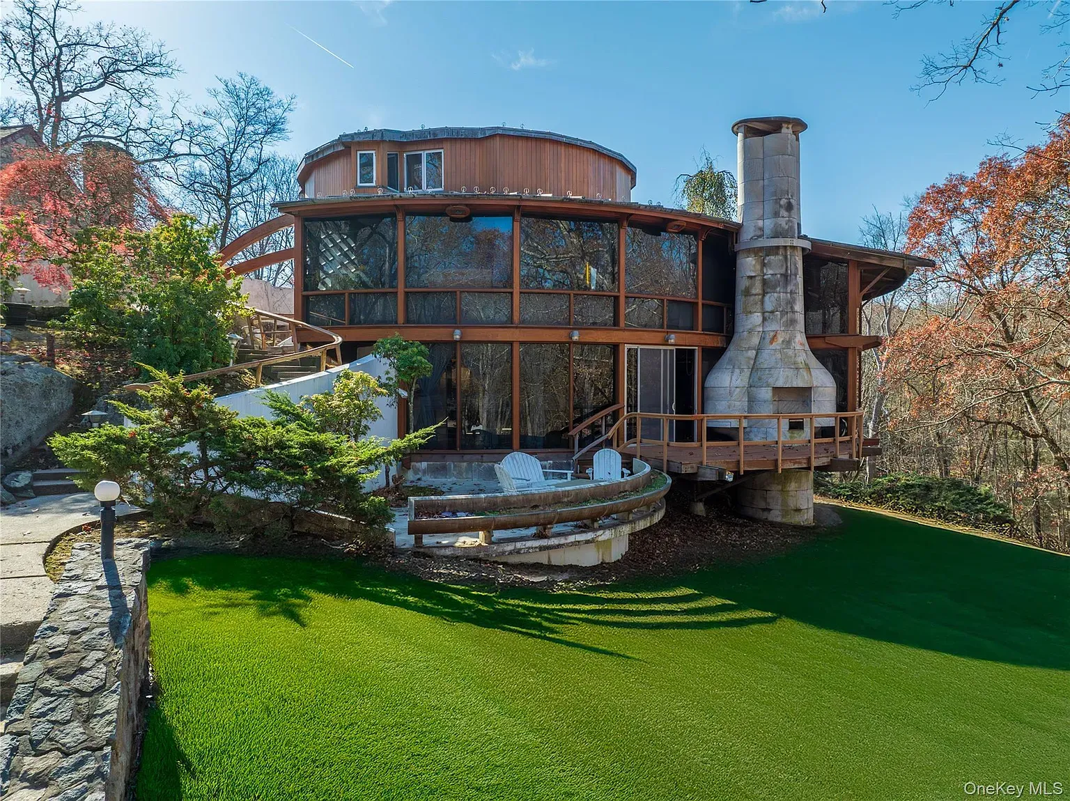 Outside again, rings of wood and glass. Kinda a grown-up treehouse.