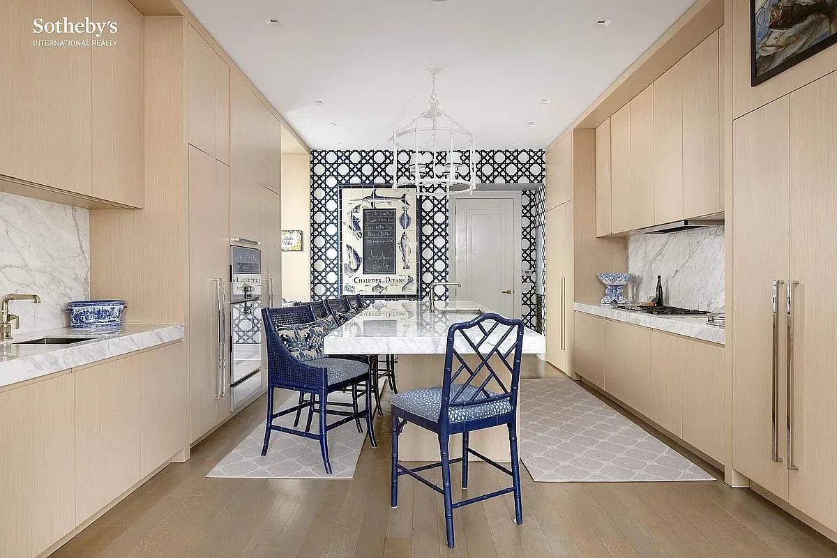 Here's the kitchen — light oak, white marble everywhere. Warm but still super sleek.