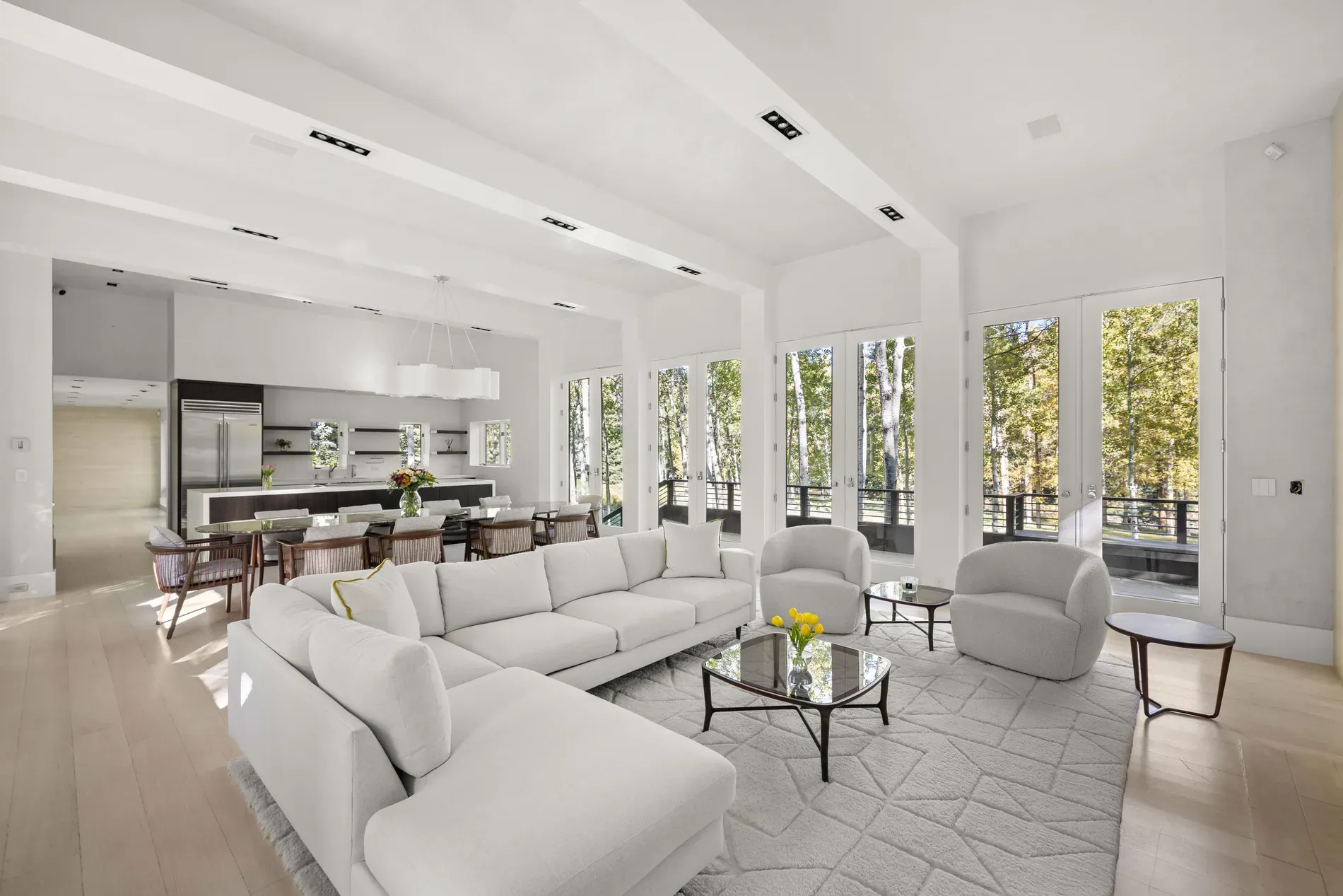 Here's the living room — huge windows, soft walls, trees everywhere. Instant zen.