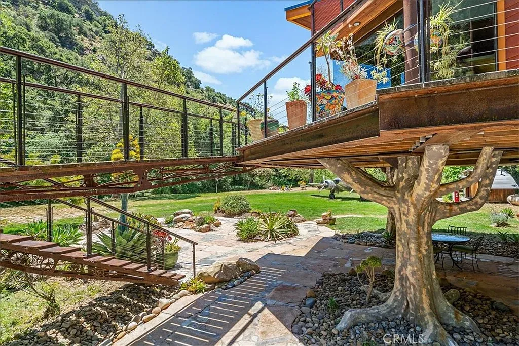 Rusty steel frame looks industrial but friendly with all those flowers.