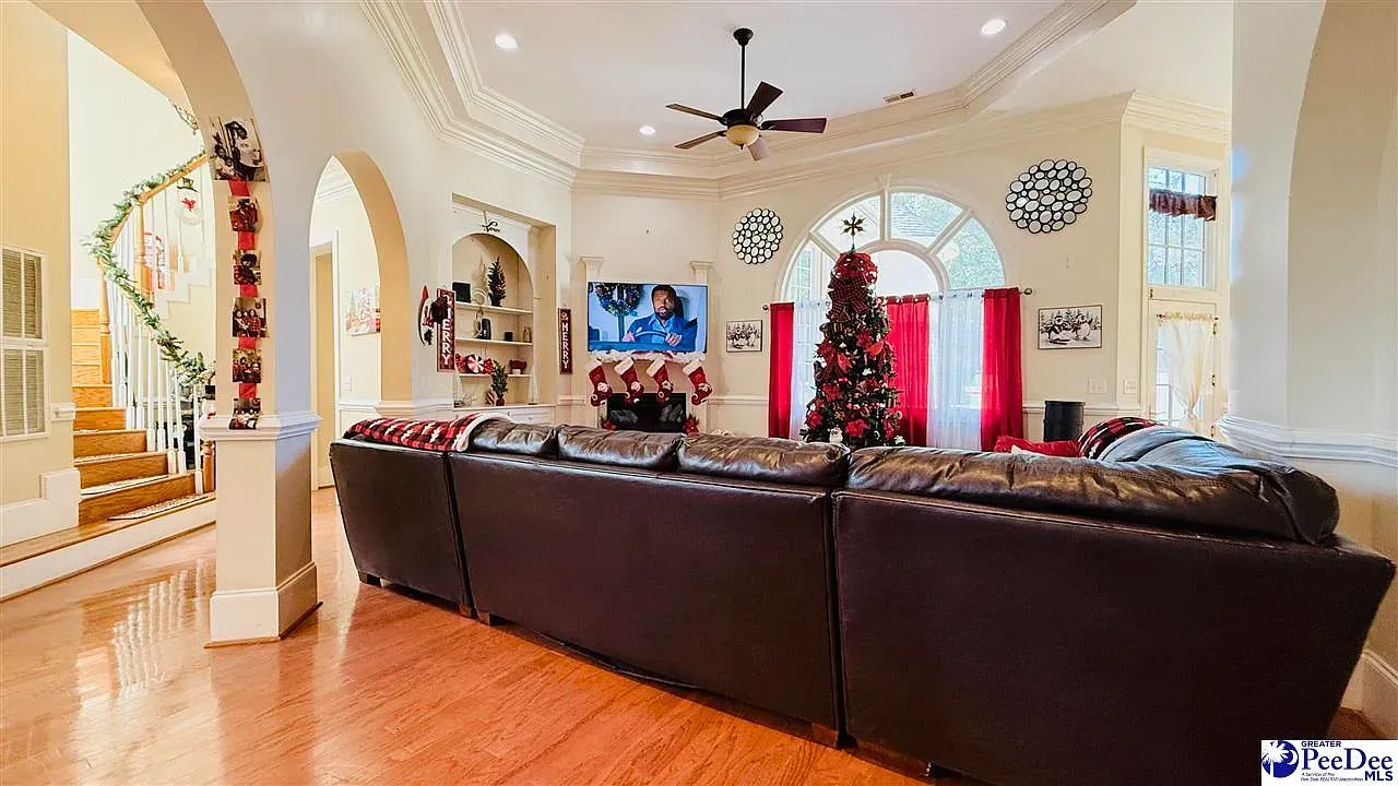 Big chocolate sectional facing the TV. Floors are super shiny.