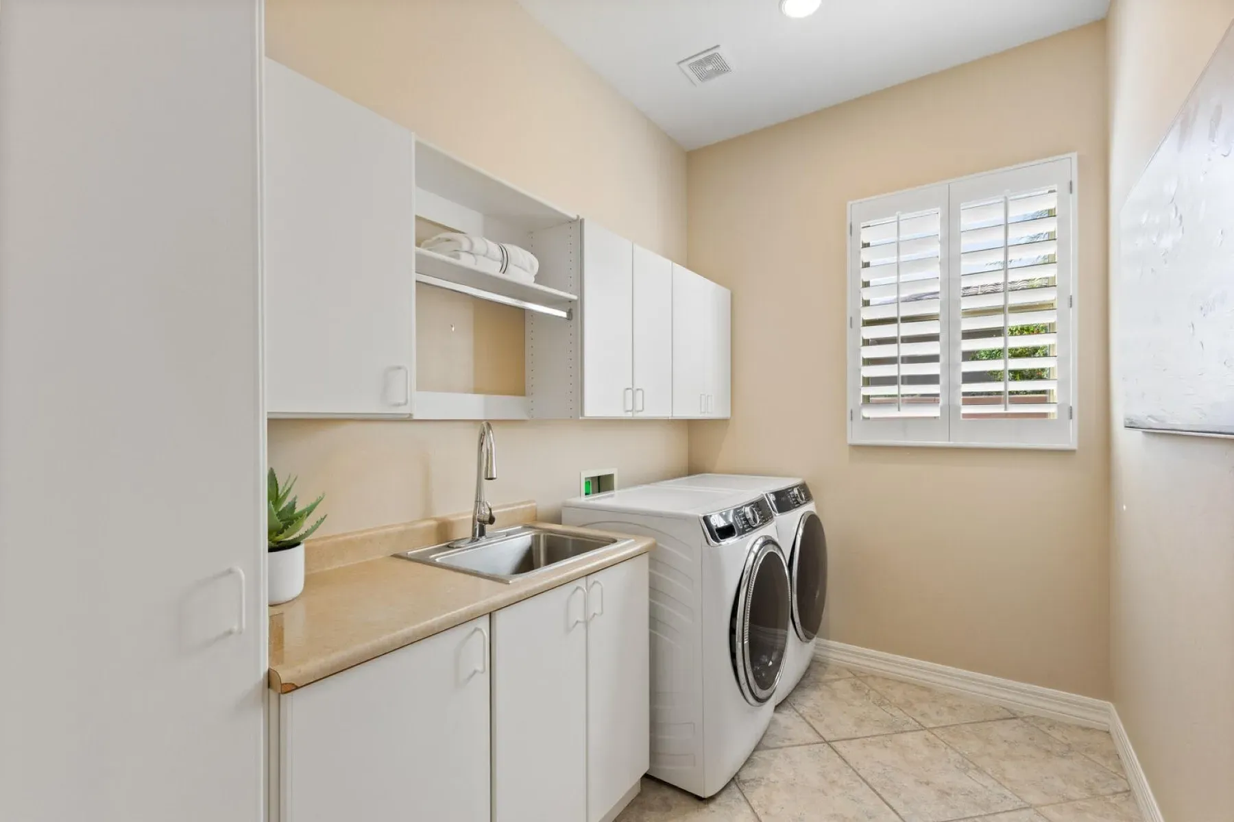 Laundry room is spotless. Lots of white cabinets to hide the chaos.