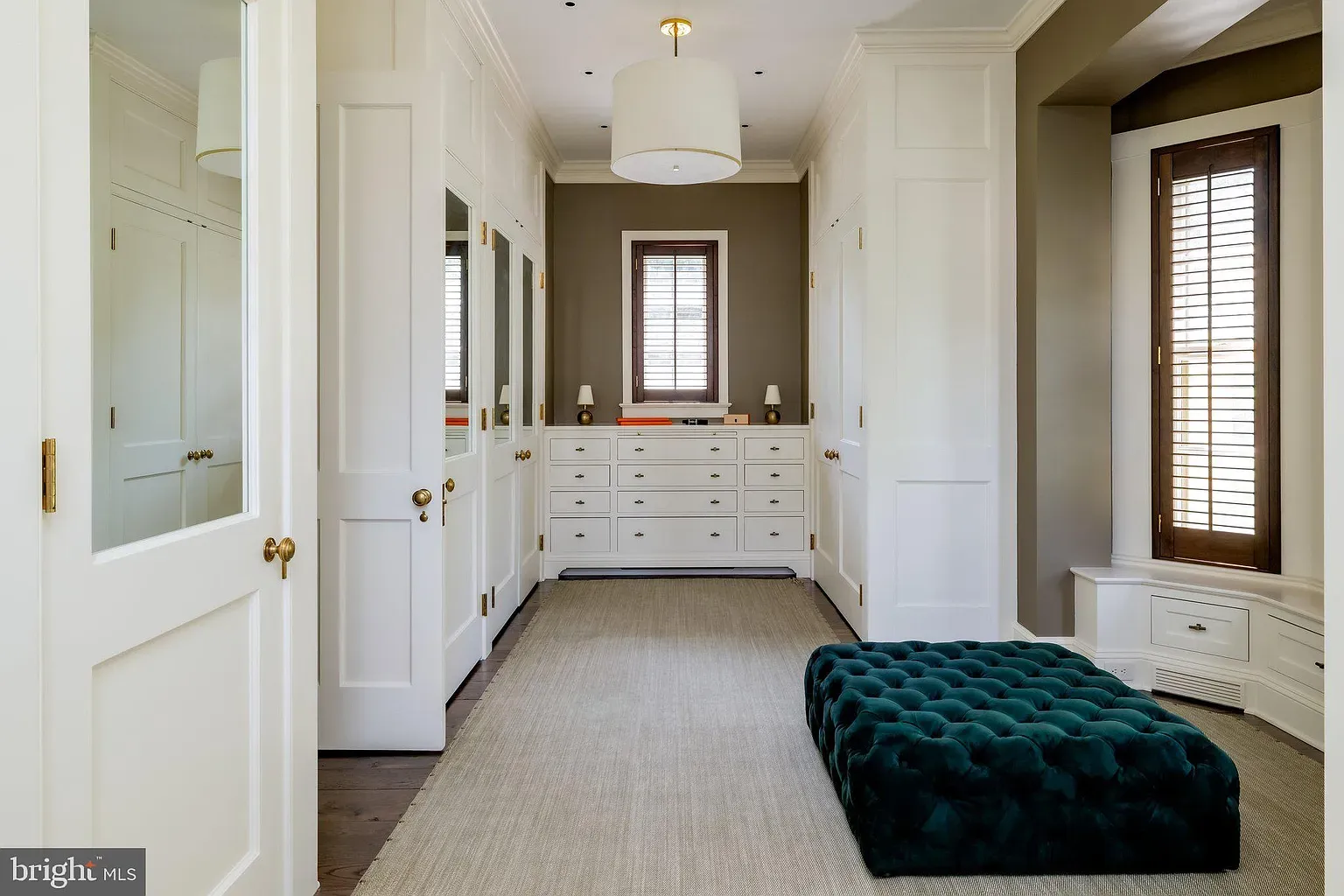 White paneled dressing room. Crisp, organized, probably hides chaos.