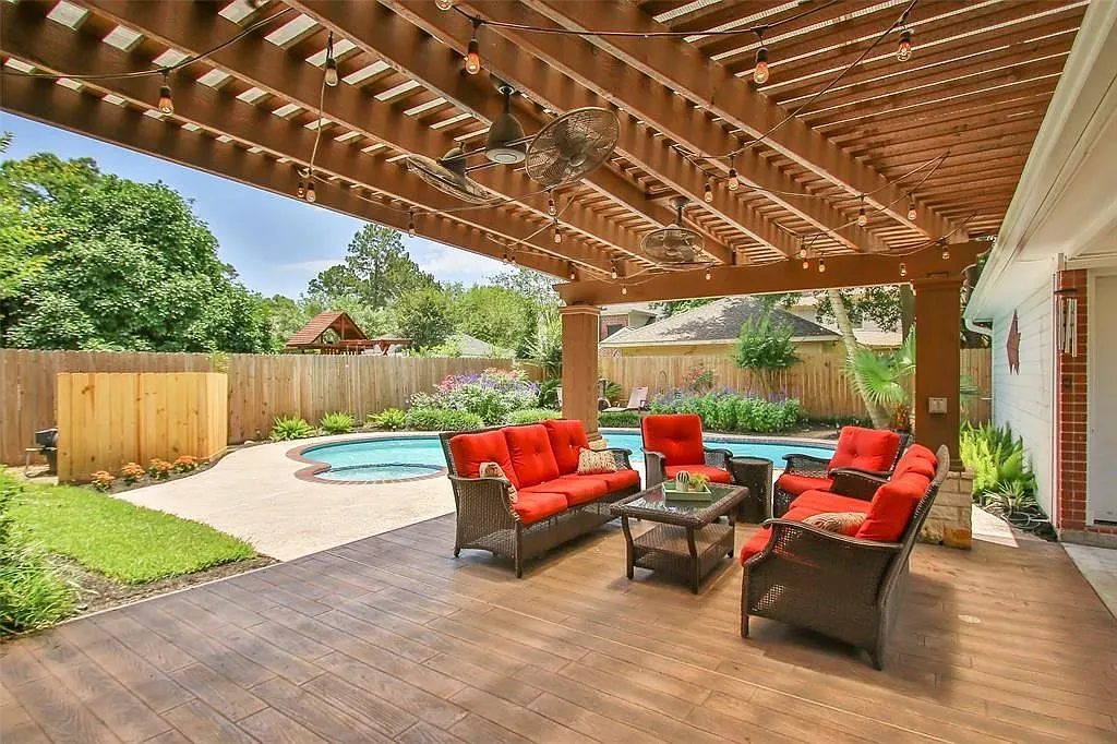Covered patio with a clean pergola. Filtered light, easy breezes, chill hangout spot.