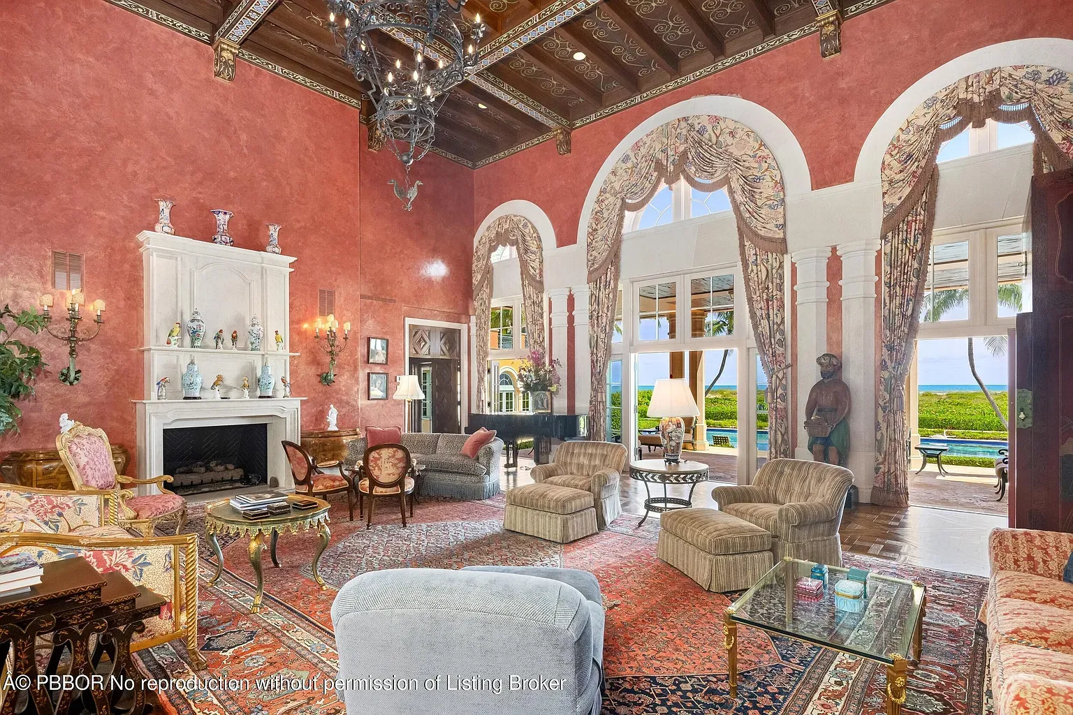The living room goes full drama. high ceilings, carved wood, terracotta walls.