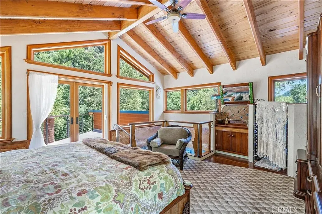 Vaulted beams and huge windows. Imagine waking up to those trees.