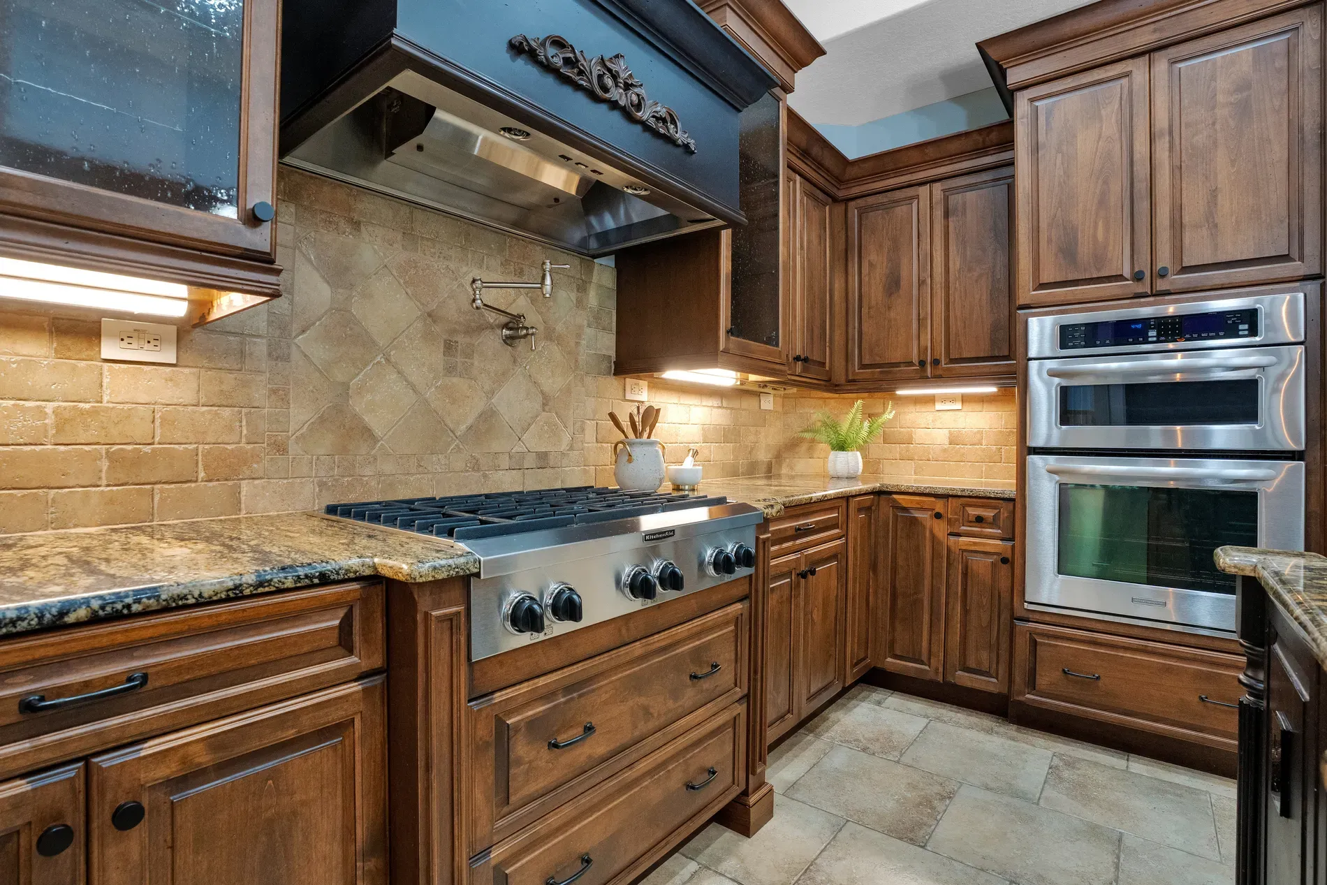 Second angle. rustic cabinet details, chunky hood. Why is the hood gigantic?