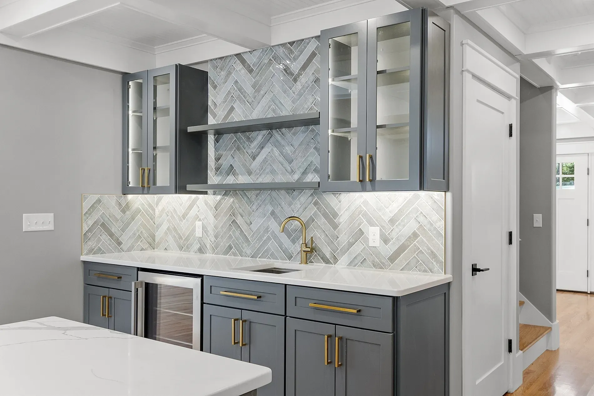 That herringbone backsplash with the glass uppers is doing the most (in a good way).