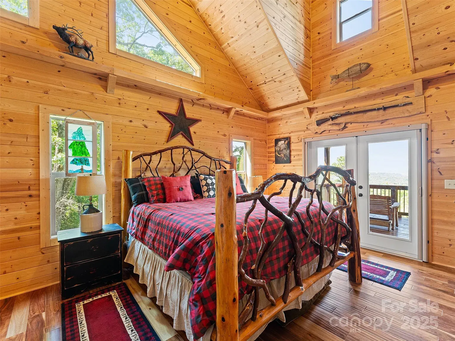 Bedroom is all warm planks and beams. Looks sleeping in a treehouse.