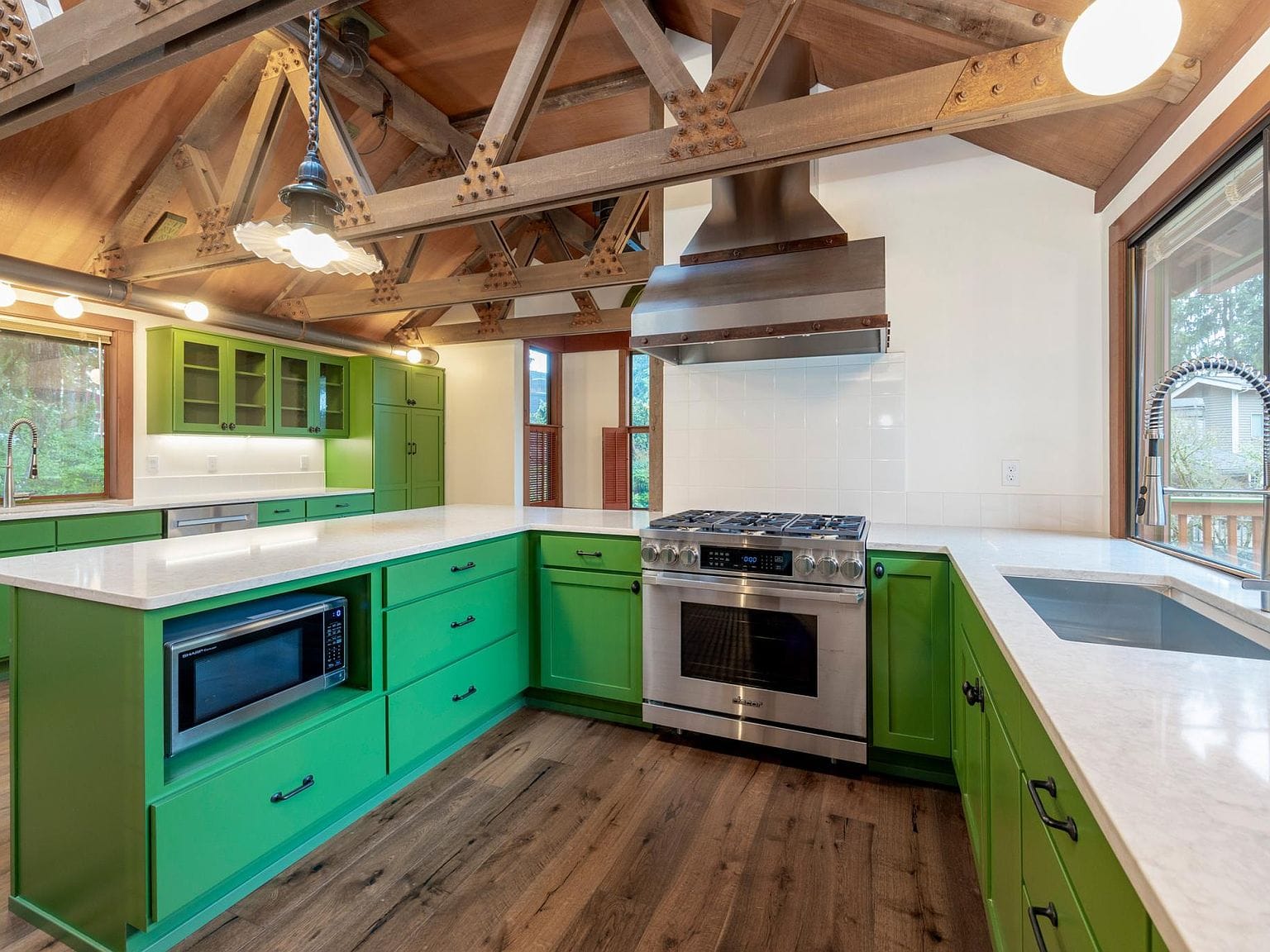 Kitchen island, green cabinets, trusses