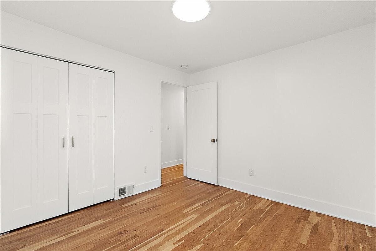 Empty bedroom view looking toward the entry door