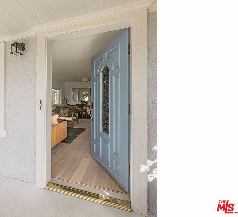 View through the open light blue front door into the main living room