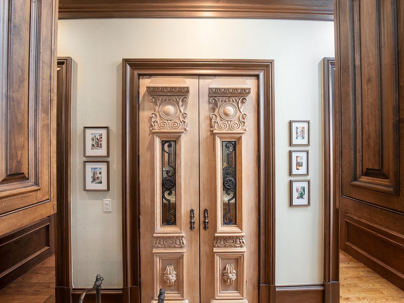 Ornate carved wooden double doors in the hallway