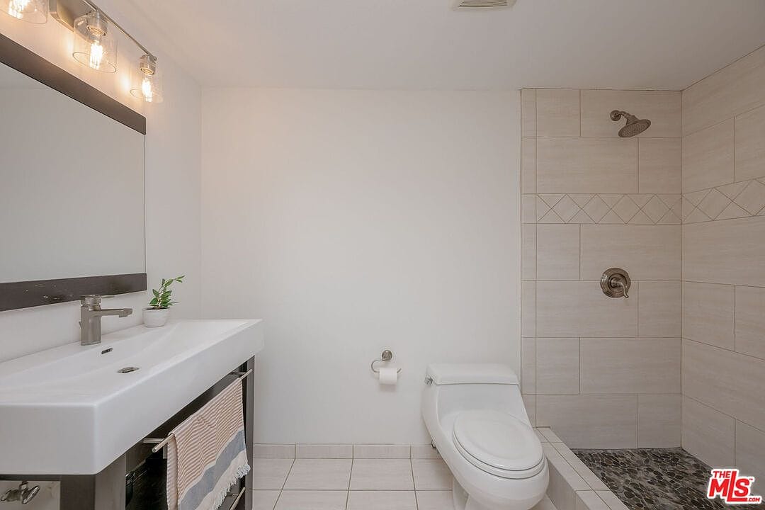 Updated downstairs bathroom with a modern vanity and tiled shower