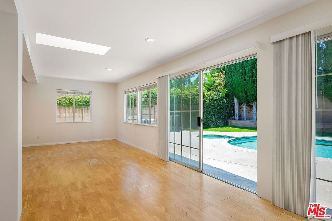 View from inside the family room looking out to the backyard pool