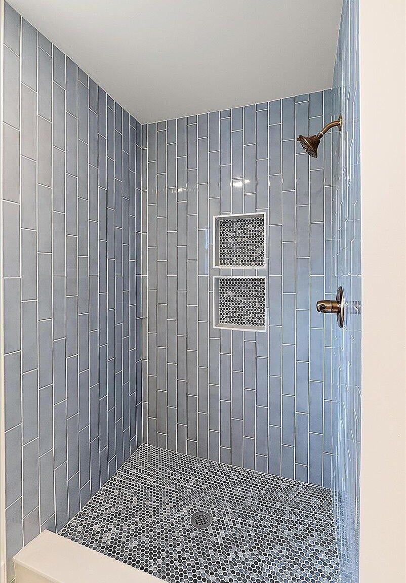 Unstaged blue shower showing the gold shower head