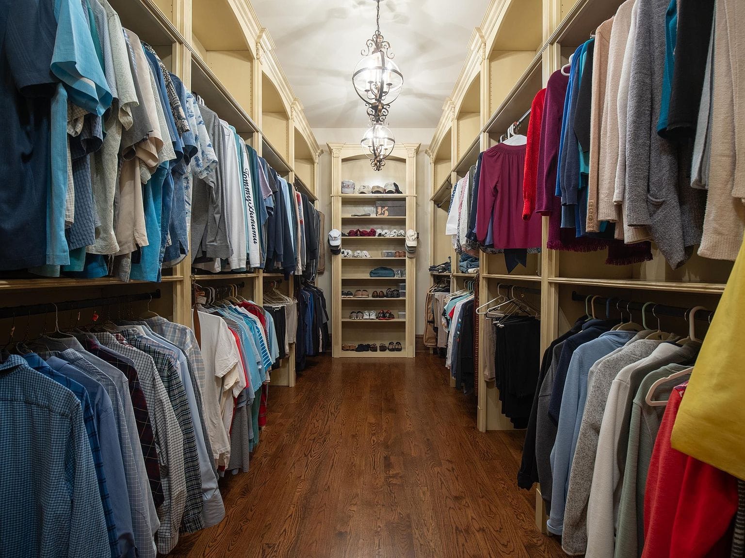 A long walk-in closet with built-in storage on both sides