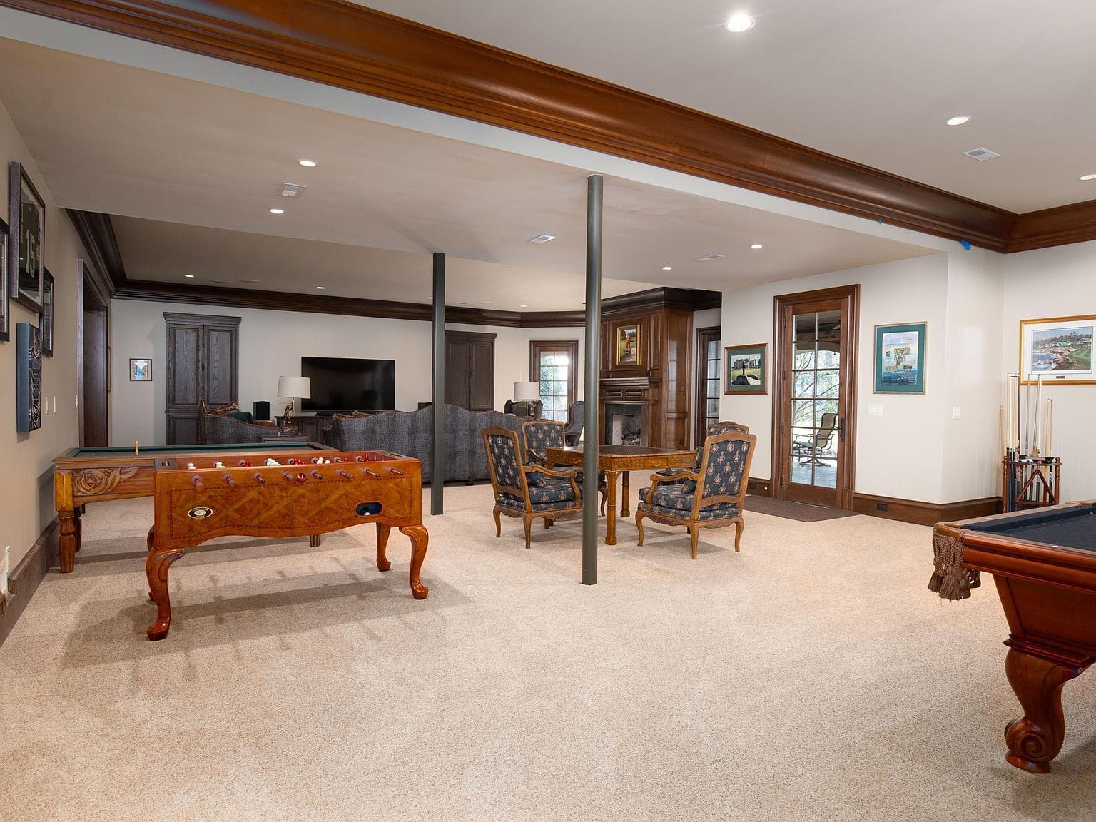 A large basement game room with a foosball table and sitting area