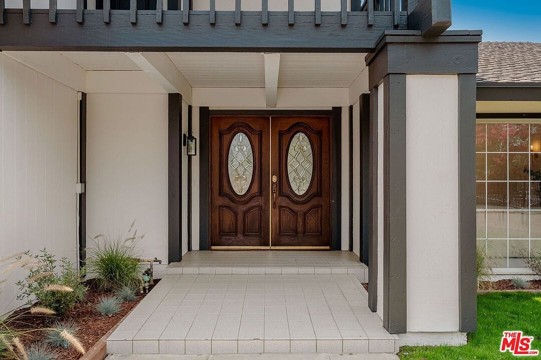 Wooden double front doors with decorative glass