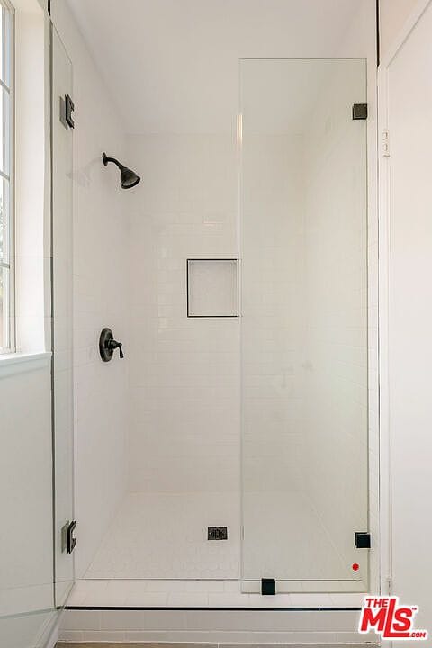 Primary walk-in shower with white subway tile