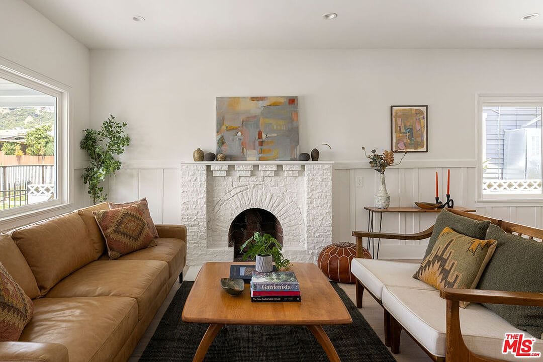 Straight-on shot of the white brick fireplace with an arched opening