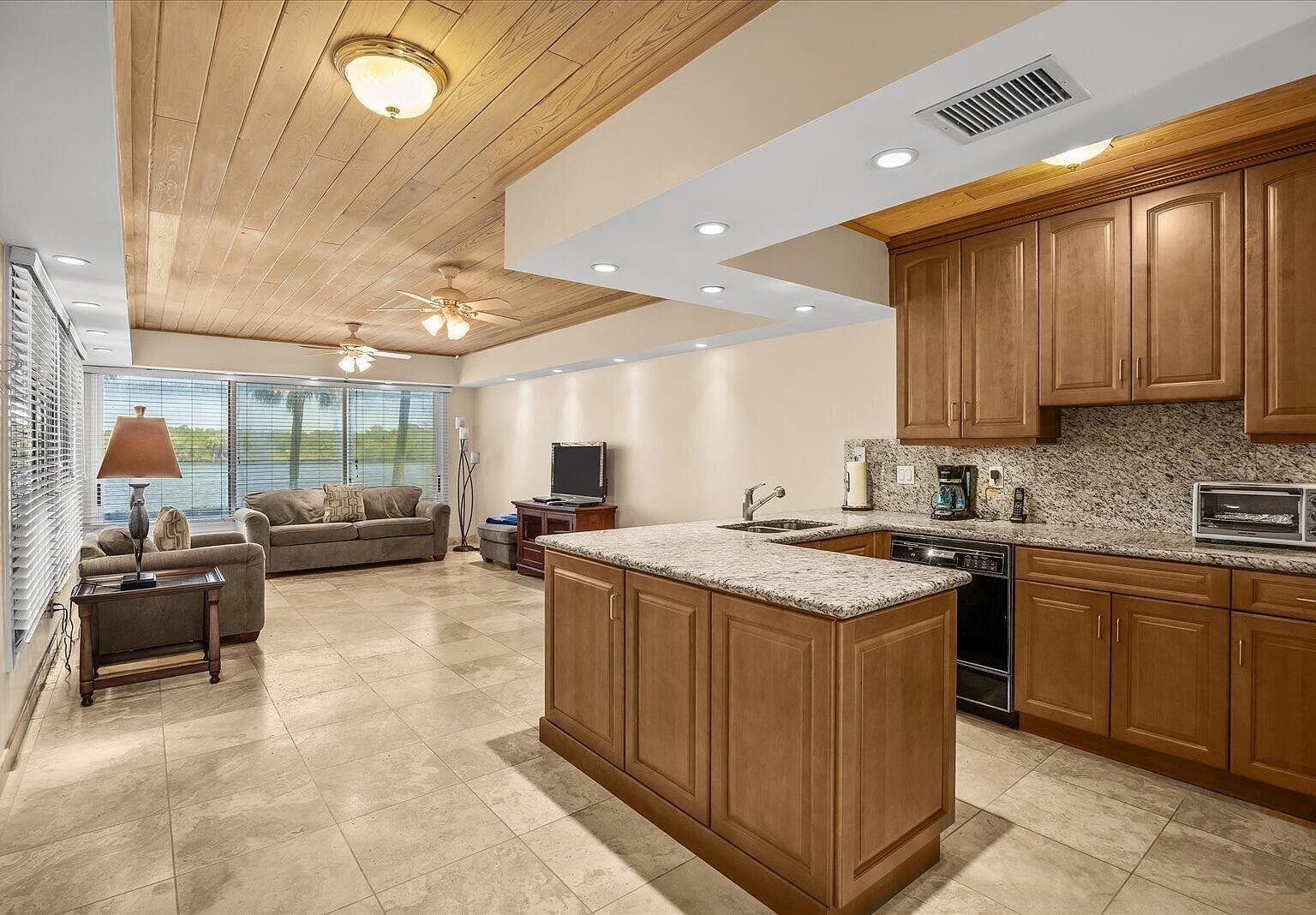 Guest house kitchen and living room setup with wood ceilings
